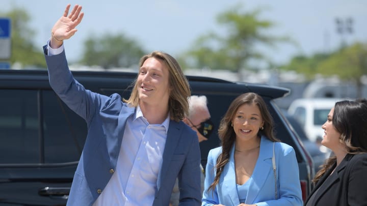 Trevor Lawrence waves at waiting students as he and his wife Marissa Mowry arrive at TIAA Bank Field Friday. The Jacksonville Jaguars' first-round draft pick Trevor Lawrence and his wife Marissa Mowry arrived at TIAA Bank Field in Jacksonville, Florida about noon Friday, April 30, 2021. The couple was greeted by team owner Shad Khan and 35 third-grade students from Long Branch Elementary School.