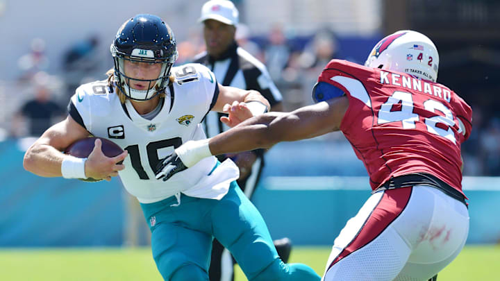 Jacksonville Jaguars quarterback Trevor Lawrence (16) tries to elude Arizona Cardinals linebacker Devon Kennard (42) on a five yard run during early second quarter action. The Jacksonville Jaguars hosted the Arizona Cardinals at TIAA Bank Field in Jacksonville, FL Sunday, September 26, 2021. The Jaguars went into the half with a 13 to 7 lead. [Bob Self/Florida Times-Union]

Jki 092621 Bsjagsvscardina 22