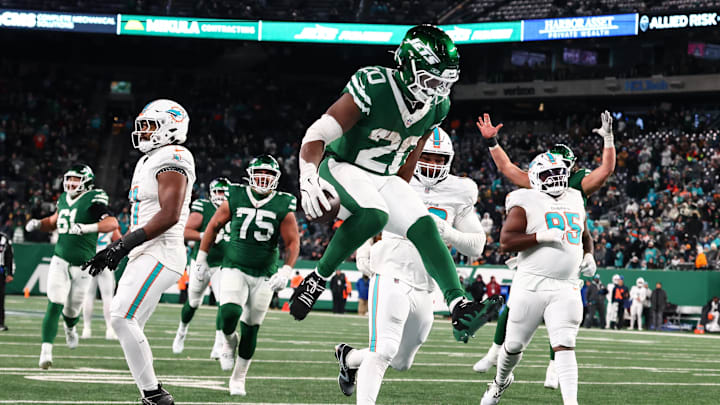 Jan 5, 2025; East Rutherford, New Jersey, USA; New York Jets running back Breece Hall (20) scores a touchdown during the fourth quarter of their game against the Miami Dolphins at MetLife Stadium. Mandatory Credit: Ed Mulholland-Imagn Images
