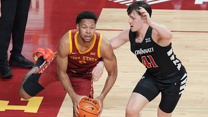 Iowa State Cyclones forward Joshua Jefferson (2) passes the ball around Cincinnati Bearcats' guard/forward Simas Lukošius (41) during the first half in the Big-12 men’s basketball at Hilton Coliseum on Feb. 15, 2025 in Ames, Iowa.
