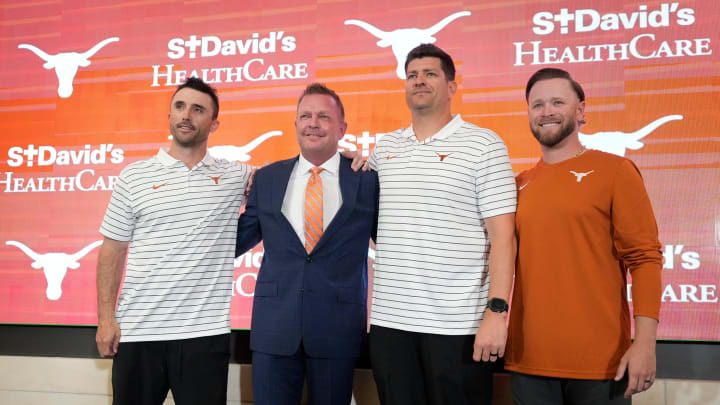 University of Texas baseball coach Jim Schlossnagle, second from left, poses for photos with his assistant coaches, left to right, Michael Earley, Nolan Cain, Max Weinerat his introductory news conference at the Frank Denius Family University Hall of Fame Wednesday June 26, 2024. University of Texas baseball coach Jim Schlossnagle, second from left, poses for photos with his assistant coaches, left to right, Michael Earley, Nolan Cain, Max Weinerat his introductory news conference at the Frank Denius Family University Hall of Fame Wednesday June 26, 2024.