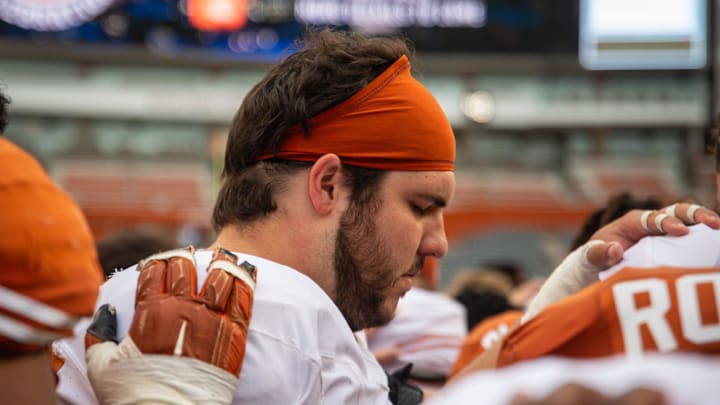 Texas White team offensive lineman Jake Majors (65) prays with the team following the Longhorns' spring Orange and White game at Darrell K Royal Texas Memorial Stadium in Austin, Texas, April 20, 2024. Texas White team offensive lineman Jake Majors (65) prays with the team following the Longhorns' spring Orange and White game at Darrell K Royal Texas Memorial Stadium in Austin, Texas, April 20, 2024.