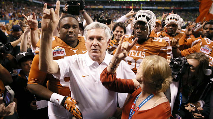 Dec 30, 2013; San Antonio, TX, USA; Texas coach Mack Brown sings the school song after the game against Oregon Ducks at Alamo Dome. Oregon defeated Texas 30-7. Mandatory Credit: Soobum Im-Imagn Images