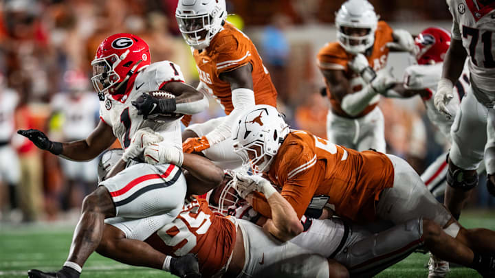 Oct 19, 2024; Austin, Texas, USA; Texa defense works to bring down Georgia Bulldogs wide receiver Arian Smith (11) in the fourth quarter of the game against the Georgia Bulldogs at Darrell K Royal-Texas Memorial Stadium. Sara Diggins/USA TODAY Network via Imagn Images Oct 19, 2024; Austin, Texas, USA; Texa defense works to bring down Georgia Bulldogs wide receiver Arian Smith (11) in the fourth quarter of the game against the Georgia Bulldogs at Darrell K Royal-Texas Memorial Stadium. Sara Diggins/USA TODAY Network via Imagn Images