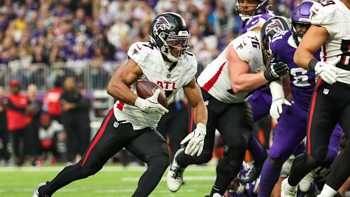 Dec 8, 2024; Minneapolis, Minnesota, USA; Atlanta Falcons running back Bijan Robinson (7) runs the ball against the Minnesota Vikings during the third quarter at U.S. Bank Stadium. Mandatory Credit: Matt Krohn-Imagn Images