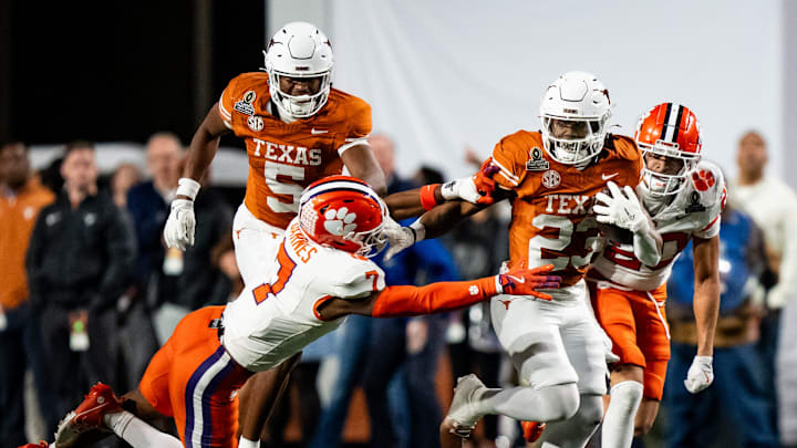 Texas Longhorns running back Jaydon Blue (23) evades a tackle from Clemson Tigers safety Khalil Barnes (7) to run the ball in for a touchdown in the fourth quarter as the Texas Longhorns play the Clemson Tigers in the first round of the College Football Playoffs at Darrell K Royal Texas Memorial Stadium in Austin, Texas, Dec. 21, 2024.