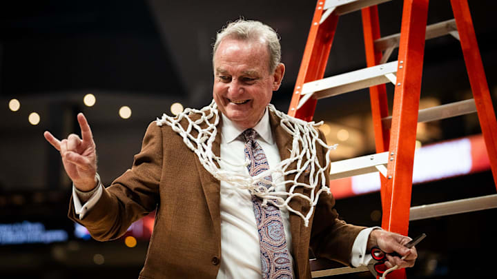 Texas Longhorns head coach Vic Schaefer poses for a photo with the net to celebrate the Longhorns' SEC victory following their win over the Florida Gators, March 2, 2025. With the 72-46 win over the Gators, the Texas Longhorns become regular season SEC Champions.
