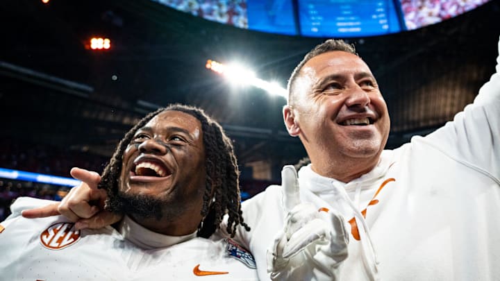 Texas Longhorns running back Jaydon Blue (23) and head coach Steve Sarkisian celebrate the Longhorns 39-31 double overtime win over the Arizona State Sun Devils in the Peach Bowl College Football Playoff quarterfinal at Mercedes-Benz Stadium in Atlanta, Georgia, Jan. 1, 2025.