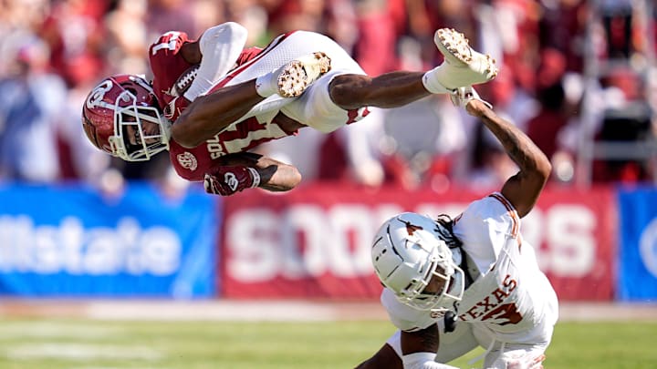Oklahoma Sooners wide receiver J.J. Hester (13) is up ended by defesive back Jaylon Guilbeau (3) in the first half of the Red River Rivalry college football game between the University of Oklahoma Sooners and the Texas Longhorn at the Cotton Bowl Stadium in Dallas, Texas, Saturday, Oct., 12, 2024. Oklahoma Sooners wide receiver J.J. Hester (13) is up ended by defesive back Jaylon Guilbeau (3) in the first half of the Red River Rivalry college football game between the University of Oklahoma Sooners and the Texas Longhorn at the Cotton Bowl Stadium in Dallas, Texas, Saturday, Oct., 12, 2024.
