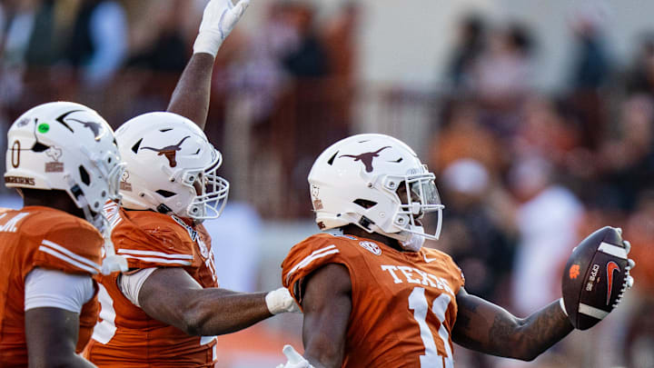 Texas Longhorns linebacker Colin Simmons (11) celebrates an interception in the second quarter as the Texas Longhorns play the Clemson Tigers in the first round of the College Football Playoffs at Darrell K Royal Texas Memorial Stadium in Austin, Texas, Dec. 21, 2024.