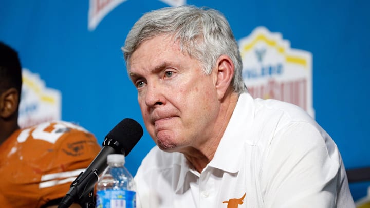 Dec 30, 2013; San Antonio, TX, USA; Texas Longhorns head coach Mack Brown reacts during the post game press conference after a game against the Oregon Ducks at Alamo Dome. Oregon defeated Texas 30-7. Mandatory Credit: Soobum Im-Imagn Images