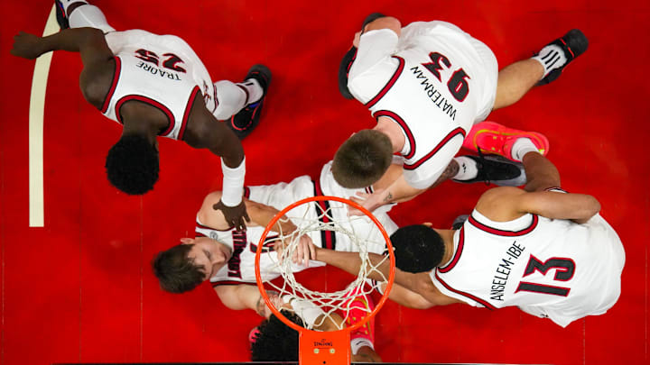Louisville’s teammates swarm to help Reyne Smith up in the first half against North Carolina. Louisville beat North Carolina 83-70 at the KFC Yum! Center on the first night of ACC play. January 1, 2025