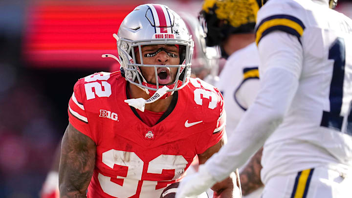 Ohio State Buckeyes running back TreVeyon Henderson (32) celebrates a run during the NCAA football game against the Michigan Wolverines at Ohio Stadium in Columbus on Tuesday, Dec. 3, 2024. Michigan won 13-10.