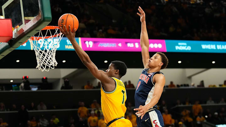 Feb 17, 2025; Waco, Texas, USA;  Baylor Bears guard VJ Edgecombe (7) shoots ahead of Arizona Wildcats forward Carter Bryant (9) during the first half at Paul and Alejandra Foster Pavilion. Mandatory Credit: Chris Jones-Imagn Images