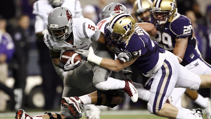 Nov 26, 2011, Seattle, WA, USA; Washington State Cougars running back Rickey Galvin (5) is tackled by Washington Huskies linebacker Cort Dennison (31) during the first half at CenturyLink Field. Mandatory Credit: Joe Nicholson-Imagn Images