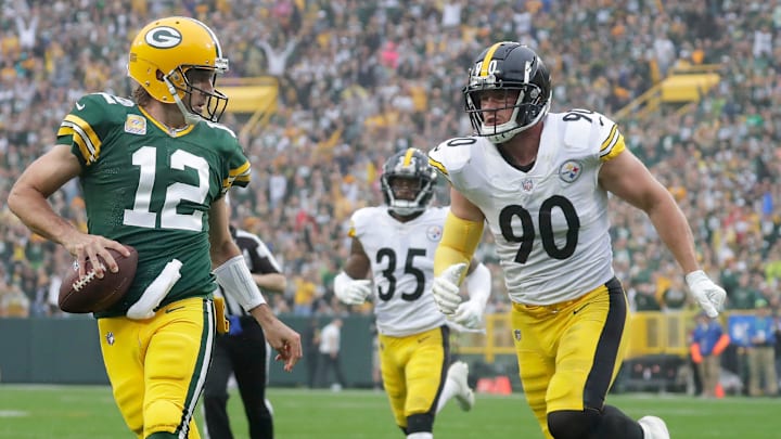 Green Bay Packers quarterback Aaron Rodgers (12) scrambles for a touchdown against T.J. Watt and the Steelers.