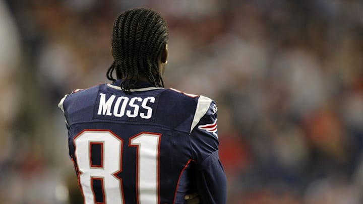 Sep 3, 2009; Foxborough, MA, USA; New England Patriots wide receiver Randy Moss (81) watches from the sideline as the Patriots take on the New York Giants during the third quarter at Gillette Stadium. The Patriots defeated the Giants 38-27. 