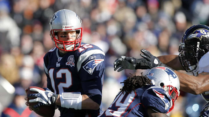 Jan 10, 2010; Foxboro, MA, USA; New England Patriots quarterback Tom Brady (12) tries to evade Baltimore Ravens linebacker Ray Lewis (right) during the first quarter of the 2010 AFC wild card playoff game at Gillette Stadium. The Ravens defeated the Patriots 33-14, Mandatory Credit: David Butler II-Imagn Images