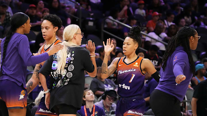 Phoenix Mercury guard Sophie Cunningham (9) greets guard Sug Sutton (1) during a time out against the Washington Mystics at Footprint Center in Phoenix on Sept. 5, 2023.