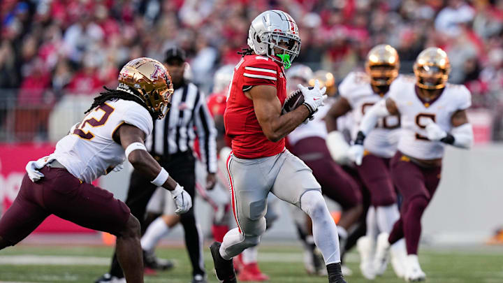 Nov 18, 2023; Columbus, Ohio, USA; Ohio State Buckeyes wide receiver Emeka Egbuka (2) catches a pass in front of Minnesota Golden Gophers defensive back Darius Green (12) during the first half of the NCAA football game at Ohio Stadium.