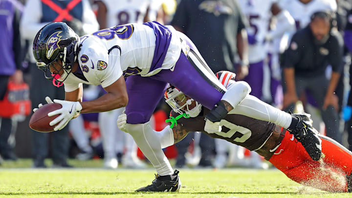 Baltimore Ravens tight end Isaiah Likely (80) dives for yards as he is brought down by Cleveland Browns safety Grant Delpit (9) during the second half of an NFL football game at Huntington Bank Field, Sunday, Oct. 27, 2024, in Cleveland, Ohio.