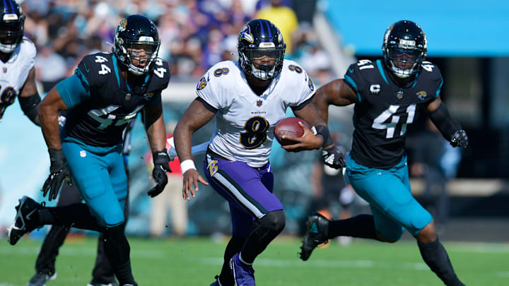 Jacksonville Jaguars linebacker Travon Walker (44) and linebacker Josh Allen (41) try to run down Baltimore Ravens quarterback Lamar Jackson (8) during early fourth quarter action. Offsetting penalties negated the play. The Jacksonville Jaguars hosted the Baltimore Ravens at TIAA Bank Field in Jacksonville, FL Sunday, November 27, 2022. [Bob Self/Florida Times-Union]

Jki 112722 Bs Jaguars Vs Ravens 44