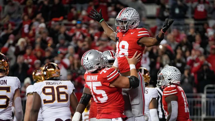 Ohio State Buckeyes offensive lineman Carson Hinzman (75) hoists wide receiver Marvin Harrison Jr. Ohio State Buckeyes offensive lineman Carson Hinzman (75) hoists wide receiver Marvin Harrison Jr.