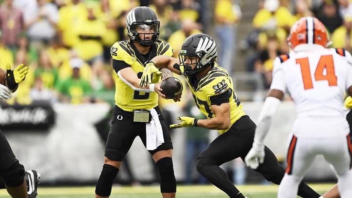 Oct 26, 2024; Eugene, Oregon, USA; Oregon Ducks quarterback Dillon Gabriel (8) hands the ball to running back Jayden Limar (27) during the second half at Autzen Stadium. Mandatory Credit: Troy Wayrynen-Imagn Images