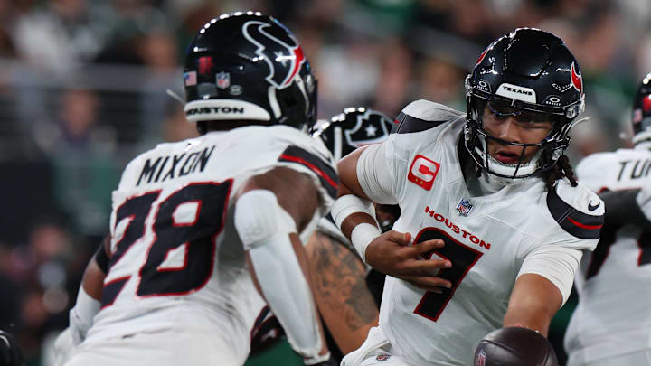 Oct 31, 2024; East Rutherford, New Jersey, USA; Houston Texans quarterback C.J. Stroud (7) hands the ball to Houston Texans running back Joe Mixon (28) against the New York Jets during the first half at MetLife Stadium. Mandatory Credit: Ed Mulholland-Imagn Images