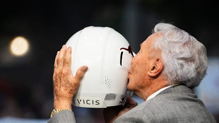 Analyst Lee Corso kisses a Texas football helmet before ESPN's College Game Day, at the University of Texas on the South Mall, ahead of the Longhorns' game against the Georgia Bulldogs in Austin, Oct. 19, 2024.