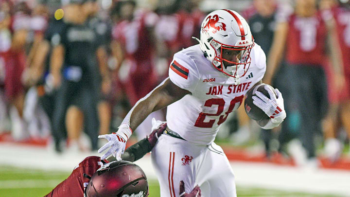 Jacksonville State's Tre Stewart tries to evade the tackle of NM State's Da'Marcus Crosby during college football action at AmFirst Stadium in Jacksonville, Alabama October 9, 2024. (Dave Hyatt / Special to the Gadsden Times)