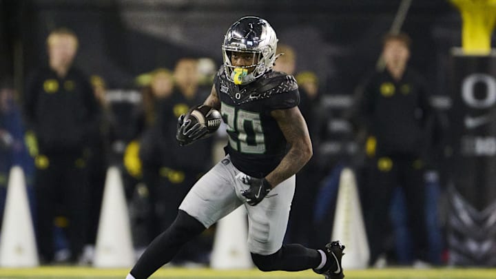 Nov 30, 2024; Eugene, Oregon, USA; Oregon Ducks running back Jordan James (20) carries the ball during the second half against the Washington Huskies at Autzen Stadium. Mandatory Credit: Troy Wayrynen-Imagn Images