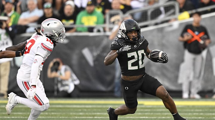 Oct 12, 2024; Eugene, Oregon, USA; Oregon Ducks running back Jordan James (20) runs with the ball during the first half against Ohio State Buckeyes cornerback Denzel Burke (10) at Autzen Stadium. Mandatory Credit: Troy Wayrynen-Imagn Images Oct 12, 2024; Eugene, Oregon, USA; Oregon Ducks running back Jordan James (20) runs with the ball during the first half against Ohio State Buckeyes cornerback Denzel Burke (10) at Autzen Stadium. Mandatory Credit: Troy Wayrynen-Imagn Images