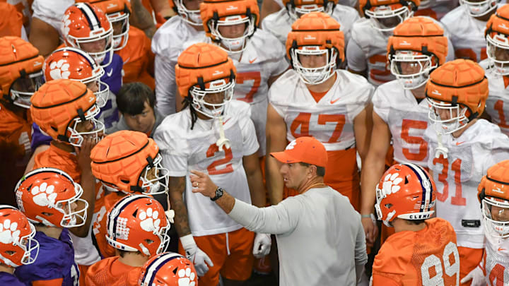 Swinney talks with Clemson players during a spring practice in February.