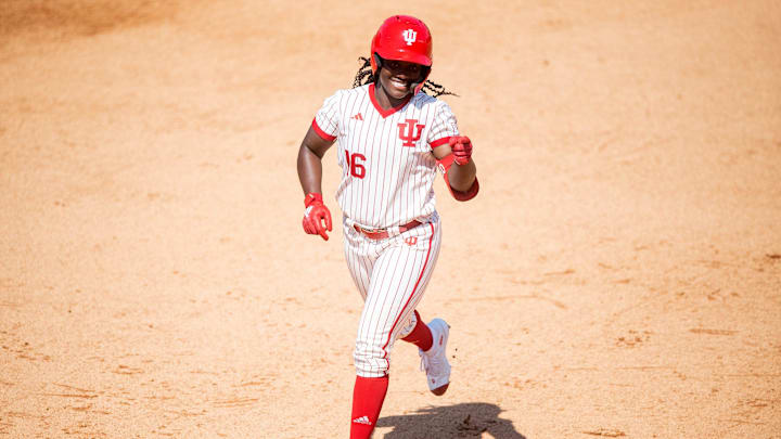 Indiana's Brianna Copeland (16) points to her teammates in the dugout as she celebrates hitting a home run while running the bases during an NCAA Regional softball game between Indiana and Louisville at Sherri Parker Lee Stadium in Knoxville, Tenn., on Friday, May 19, 2023.