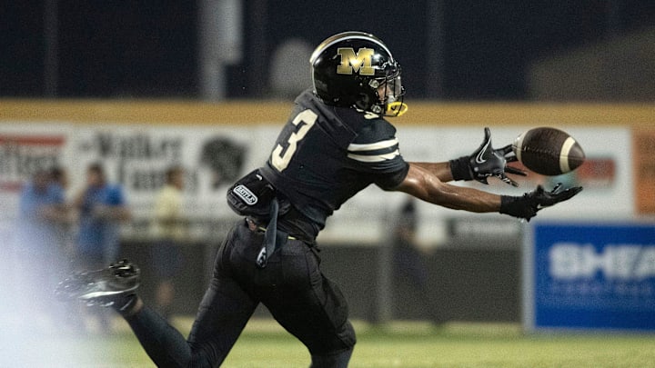 Milton's Kaiden Hall No. 3) pulls in the pass for a huge gain against the Gulf Breeze defense during