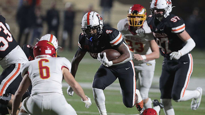 Massillon's Nolan Davenport (97) watches teammate Willtrell Hartson (4) run through a hole vs. Big Walnut at Mansfield's Arlin Field in a Division II high school football playoff game Friday, Nov. 11, 2022.