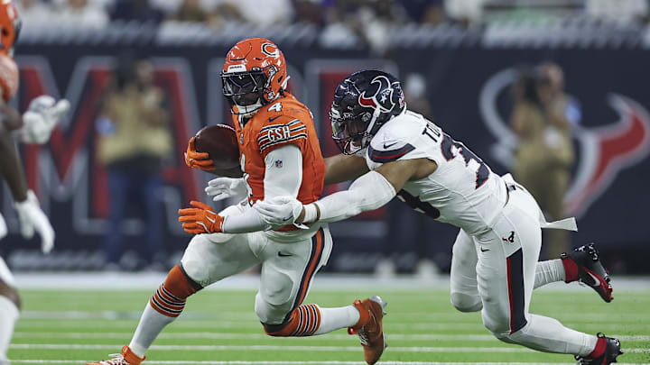 Sep 15, 2024; Houston, Texas, USA; Chicago Bears running back D'Andre Swift (4) runs with the ball as Houston Texans linebacker Henry To'oTo'o (39) attempts to make a tackle during the first quarter at NRG Stadium. Mandatory Credit: Troy Taormina-Imagn Images