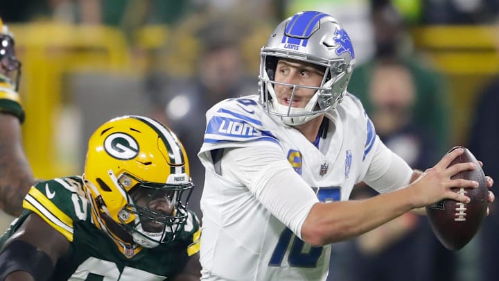 Green Bay Packers defensive tackle Devonte Wyatt (95) chases Detroit Lions quarterback Jared Goff (16) during their football game Thursday, September 28, 2023, at Lambeau Field in Green Bay, Wis.