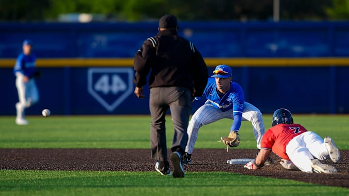 Memphis' Creek Robertson (1) prepares to tag out Ole Miss' Luke Hill (7) as he slides into second base during the game between Ole Miss and the University of Memphis at FedExPark in Memphis, Tenn., on Tuesday, April 8, 2025.