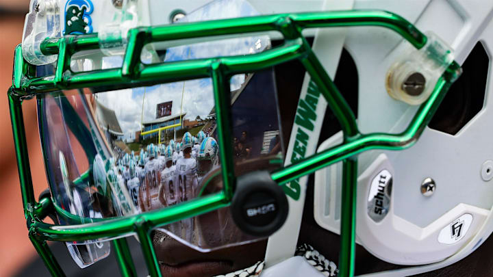Oct 28, 2023; Houston, Texas, USA; The facemark of Tulane Green Wave defensive back Rayshawn Pleasant (25) reflects his teammates as he warms up before a game against the Rice Owls. Oct 28, 2023; Houston, Texas, USA; The facemark of Tulane Green Wave defensive back Rayshawn Pleasant (25) reflects his teammates as he warms up before a game against the Rice Owls.