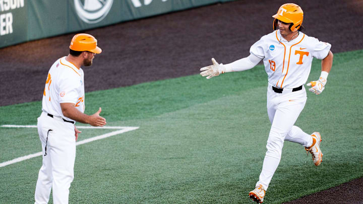 Tennessee's Reese Chapman (13) celebrates a home run with Tennessee assistant head coach Josh Elander, left, during a NCAA Baseball Tournament Knoxville Regional game between Tennessee and Miami Ohio on May 30, 2025.