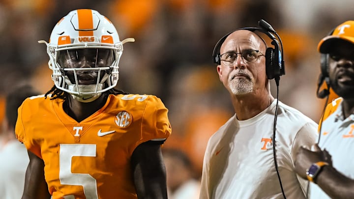 Sep 17, 2022; Knoxville, Tennessee, USA; Tennessee Volunteers quarterback Hendon Hooker (5) and secondary coach Willie Martinez look on during the first half against the Akron Zips at Neyland Stadium. Mandatory Credit: Bryan Lynn-Imagn Images