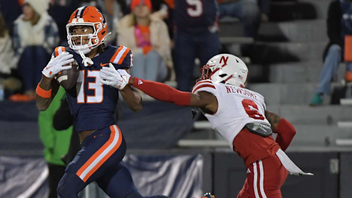 Oct 6, 2023; Champaign, Illinois, USA; Illinois Fighting Illini wide receiver Pat Bryant (13) catches a pass for a touchdown in front of Nebraska Cornhuskers defensive back Quinton Newsome (6) during the first half at Memorial Stadium. Mandatory Credit: Ron Johnson-Imagn Images