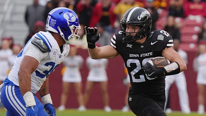 Iowa State Cyclones' running back Carson Hansen (26) runs with the ball for a first down as BYU Cougars linebacker Max Alford (30) defends at Jack Trice Stadium on Oct. 25, 2025, in Ames, Iowa.
