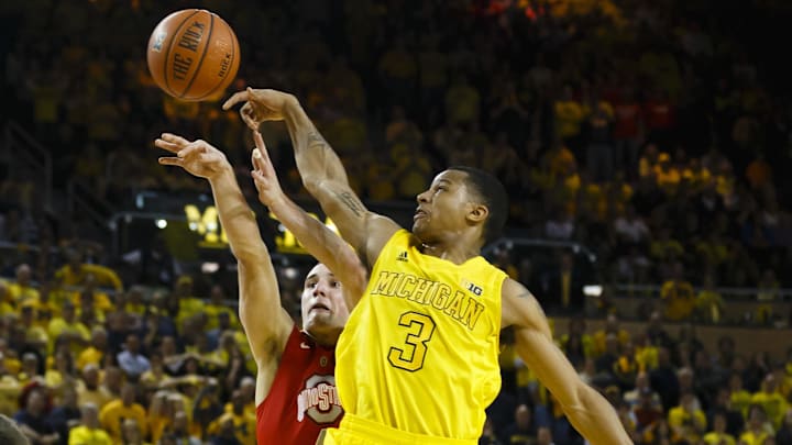 Feb 5, 2013; Ann Arbor, MI, USA; Michigan Wolverines guard Trey Burke (3) blocks the shot of Ohio State Buckeyes guard Aaron Craft (4) in over time at Crisler Center. Michigan won 76-74. Mandatory Credit: Rick Osentoski-Imagn Images