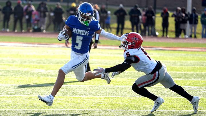 Detroit Catholic Central's Samson Gash runs with the ball against the defense of East Kentwood's Donavan Jones during the second half of the MHSAA Division 1 football semifinals at Jackson High School in Jackson on Saturday, Nov. 22, 2025. Catholic Central won, 46-6. Detroit Catholic Central's Samson Gash runs with the ball against the defense of East Kentwood's Donavan Jones during the second half of the MHSAA Division 1 football semifinals at Jackson High School in Jackson on Saturday, Nov. 22, 2025. Catholic Central won, 46-6.