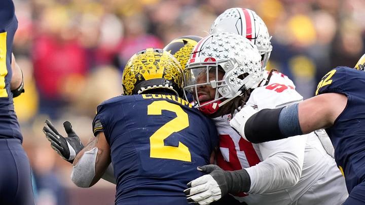 Nov 25, 2023; Ann Arbor, Michigan, USA; Ohio State Buckeyes defensive tackle Tyleik Williams (91) tackles Michigan Wolverines running back Blake Corum (2) during the NCAA football game at Michigan Stadium. Ohio State lost 30-24. Nov 25, 2023; Ann Arbor, Michigan, USA; Ohio State Buckeyes defensive tackle Tyleik Williams (91) tackles Michigan Wolverines running back Blake Corum (2) during the NCAA football game at Michigan Stadium. Ohio State lost 30-24.
