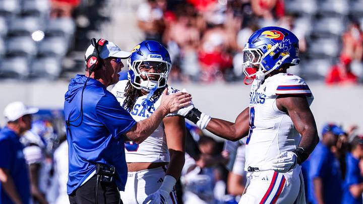 Nov 8, 2025; Tucson, Arizona, USA; Kansas Jayhawks defensive end Dakyus Brinkley (9) high fives head coach Lance Leipold during the second quarter of the game against the Arizona Wildcats at Arizona Stadium. Mandatory Credit: Aryanna Frank-Imagn Images Nov 8, 2025; Tucson, Arizona, USA; Kansas Jayhawks defensive end Dakyus Brinkley (9) high fives head coach Lance Leipold during the second quarter of the game against the Arizona Wildcats at Arizona Stadium. Mandatory Credit: Aryanna Frank-Imagn Images
