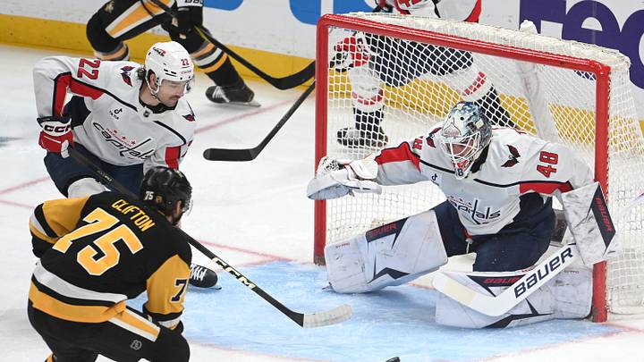 Apr 11, 2026; Pittsburgh, Pennsylvania, USA;  Pittsburgh Penguins defenseman Connor Clifton (75) pressures Washington Capitals goalie Logan Thompson (48) as left wing Brandon Duhaime (22) takes part in the play during the first period at PPG Paints Arena. Mandatory Credit: Philip G. Pavely-Imagn Images